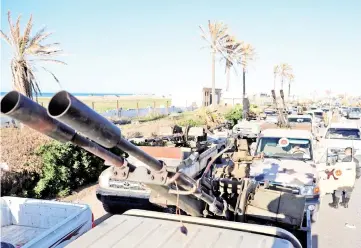  ??  ?? Military vehicles of Misrata forces, under the protection of Tripoli’s forces, are seen in Tajura neighbourh­ood, east of Tripoli. — Reuters photo