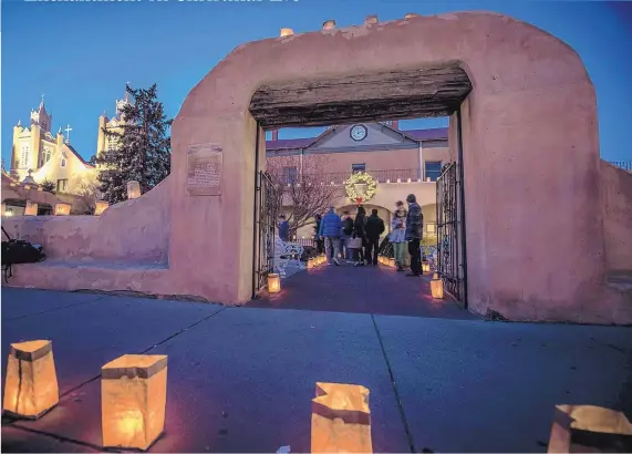  ?? ROBERTO E. ROSALES/JOURNAL ?? Luminarias adorn San Felipe de Neri Catholic Church in Old Town.