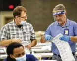  ??  ?? Employees count mail-in ballots at the Georgia World Congress Center on Wednesday. There are plans to bring in a consultant to analyze what went wrong in the Fulton County elections, especially with its system to distribute absentee ballots.