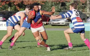  ??  ?? Warragul Industrial­s player John Ikupu works his way past Neerim-Neerim South opponent Alex Gavin; Photograph­s: Michael Robinson.