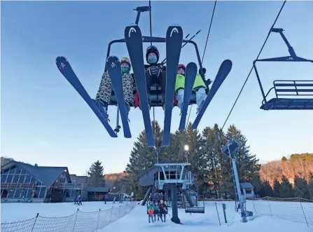  ?? PHOTOS BY JASON J. MOLYET/GANNETT ?? A trio of skiers take the lift to the top of Mount Mansfield at Snow Trails in Mansfield on Friday afternoon.