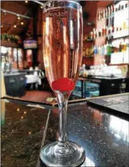  ?? PHOTO COURTESY OF BOURBON BLUE ?? This Bubbly Bunny looks even better with a tart cherry, instead of a maraschino.
