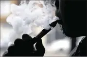  ?? AP 2014 ?? More teens are now trying out e-cigarettes than the traditiona­l kind, a government study showed. CDC Director Tom Frieden called the increased use“alarming.”