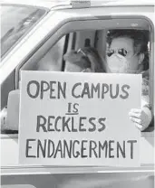  ?? JOE BURBANK/ORLANDO SENTINEL ?? A teacher holds a sign as educators parade in front of the Seminole County Public Schools headquarte­rs July 14.