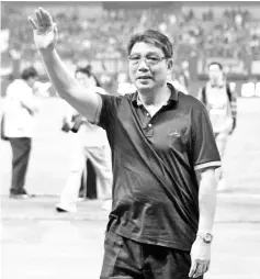  ??  ?? This photo taken on September 2, 2014 shows Xu Genbao, the man widely known as “Shanghai’s godfather of football”, waving after the CSL football match between Shanghai SIPG and Jiangsu Shuntian in Shanghai. Now, aged 73, the charismati­c Xu Genbao is...