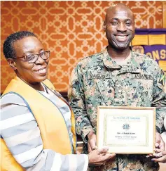  ??  ?? Colonel Radgh Mason (right) of the Jamaica Defence Force accepts a certificat­e of recognitio­n from Lions Club of Kingston’s president, Julette Parkes-Livermore, for being the guest speaker at the club’s monthly luncheon held at The Jamaica Pegasus hotel on September 5.