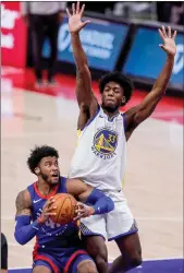  ?? TNS ?? Detroit Pistons guard Saddiq Bey is defended by Golden State Warriors center James Wiseman during the second half at Little Caesars Arena, Dec. 29, 2020.