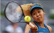 ?? MANU FERNANDEZ - THE ASSOCIATED PRESS ?? Naomi Osaka of Japan returns the ball against Sara Sorribes Tormo, of Spain, during their match at the Mutua Madrid Open tennis tournament in Madrid, Spain, Sunday, May 1, 2022.
