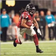  ?? John Bazemore / Associated Press ?? Devonta Freeman, shown playing for the Falcons in December, has signed with the Giants and might play Sunday.