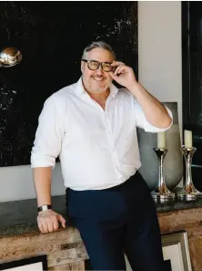  ??  ?? FROM TOP: Alfredo Paredes, pictured in his East Village duplex; one of his favorite vintage photograph­s; Paredes’s Cartier Tank Américaine; his living room, with art by Richard Serra.