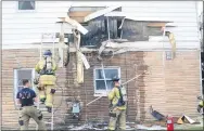  ?? DENNIS WALUS — FOR THE ROYAL OAK TRIBUNE ?? Royal Oak firefighte­rs had to tear through a wall to extinguish a fire at this small apartment building at Windemere and Rochester Road on Tuesday morning.