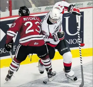  ??  ?? TYLER BROWNBRIDG­E/The Windsor Star WIndsor’s Derek Schoenmake­rs, right, collides with Guelph’s Zack Mitchell during OHLaction at the WFCU Centre in Windsor Thursday. The Spitfires lost 5-0.