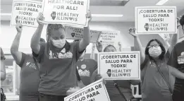  ?? SHAFKAT ANOWAR/AP ?? Members of the Health Illinois coalition in Chicago’s Pilsen neighborho­od celebrate the extension Tuesday of state health insurance coverage to immigrants 55 and over living in the country illegally. The state was the first to offer a program for seniors.