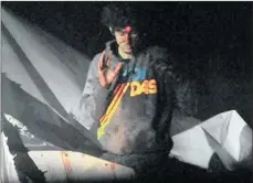  ??  ?? GRITTY: Bloodied and bruised at the moment of surrender, Dzhokhar Tsarnaev climbs from the boat where he hid for hours as a sniper aims at his head