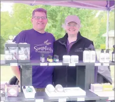  ?? Keith Bryant/The Weekly Vista ?? Rick and Kathy Henning stand at their Simplicity Lavender Farm table at the Bella Vista Farmers Market’s first outing in 2021 last Sunday.