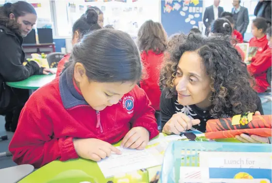  ?? Photo / Greg Bowker ?? Six-year-old Hinalei Taumoe’anga reads with NZ-born teacher¯inOKathari­neBirbalsi­nghatBaird­sSchool tara yesterday.