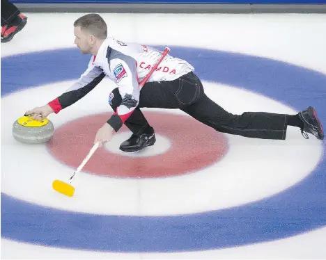  ?? JONATHAN HAYWARD /THE CANADIAN PRESS ?? Team Canada skip Brad Gushue makes a shot for a draw against Russia at the world men’s curling championsh­ip in Edmonton on Sunday morning. Gushue’s rink, which features Tom Sallows as fifth, beat Russia 11-3 and finished the day at 3-0.