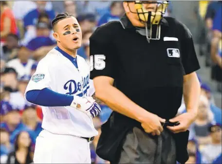  ?? Wally Skalij Los Angeles Times ?? MANNY MACHADO complains to umpire Jeff Nelson after striking out against the Boston Red Sox in the first inning, the first of his three strikeouts. The infielder batted .227 with 18 strikeouts, four walks and three home runs in 71 plate appearance­s during the playoffs.