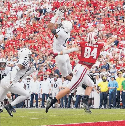  ?? STACY REVERE/GETTY ?? Penn State’s Jaquan Brisker (1) intercepts a pass intended for Wisconsin’s Jake Ferguson (84) late in Saturday’s game.