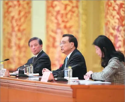  ?? BOGU / XINHUA YIN ?? Premier Li Keqiang answers questions at a news conference at the Great Hall of the People on March 11.