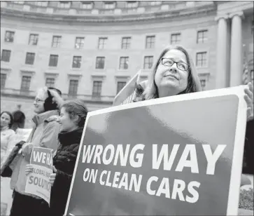  ?? Andrew Harnik Associated Press ?? PROTESTERS stand outside the U.S. Environeme­ntal Protection Agency in Washington as EPA Administra­tor Scott Pruitt announces a rollback of the vehicle fuel-efficiency goal of 55 miles per gallon by 2025.