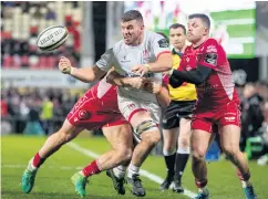  ??  ?? Tough battle: Ulster’s Sean Reidy gets his pass away despite the attention of Corey Baldwin and Steff Evans of Scarlets