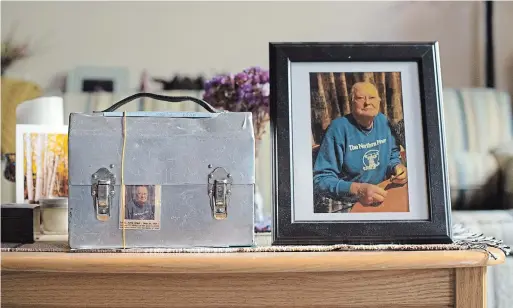  ?? MATHEW MCCARTHY PHOTOS WATERLOO REGION RECORD ?? Above: A photo of miner Moe Salo sits next to a metal lunch box that holds his cremated remains. His wife Maxine keeps the memorial at the home they shared in Elliot Lake.