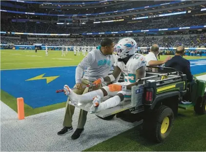  ?? MARK J. TERRILL/AP ?? Dolphins running back Jeff Wilson Jr. is carted off the field during against the Chargers on Sunday in Inglewood, California.