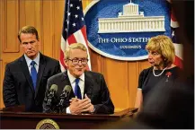  ?? JIMOTTE / STAFF ?? OhioGov. Mike DeWine announcing gun safety proposals Tuesday with Lt. Gov. Jon Husted and fifirst lady Fran DeWine.