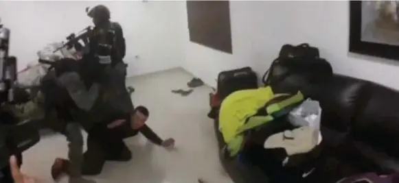  ?? REUTERS ?? A frame from a video released by the Mexican Navy shows marines detaining a man at a “safe house” during an operation to capture drug boss Joaquin (El Chapo) Guzman in Sinaloa, Mexico.