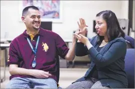  ?? Stuart Palley
For The Times ?? TANIA AMAYA uses sign language to speak to her husband, Jose. When she signs, he holds his hand over hers, reading the movements of her f ingers.