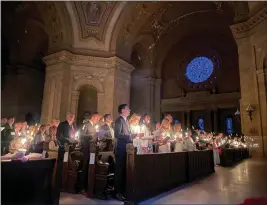  ?? PHOTOS BY GIOVANNA DELL'ORTO — THE ASSOCIATED PRESS ?? Hundreds of celebrants attend the Easter Vigil Mass at the Cathedral of St. Paul in St. Paul, Minn., on Saturday. For many U.S. Christians, the weekend marks the first time since 2019that they gathered in person on Easter Sunday.