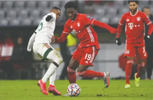  ?? ANDREAS GEBERT/ REUTERS ?? Bayern Munich's Alphonso Davies, pictured in action against Lokomotiv Moscow on Dec. 9, was named one of the best 11 players on the planet last season.