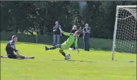  ??  ?? Paul Carmichael slides in to knock the ball past St Joseph’s keeper Sean Gibbons to make the score 2-1.