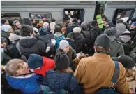  ?? (AFP) ?? People try to get an evacuation train at Kyiv train station on Saturday.