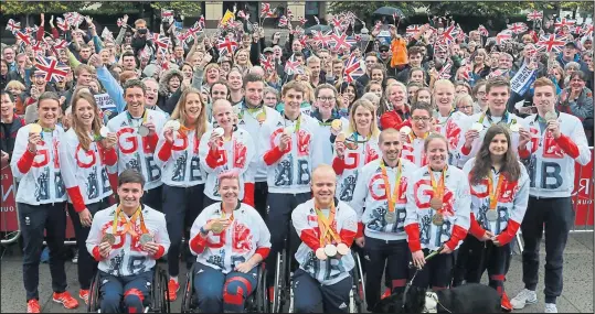  ??  ?? Scottish Olympians and Paralympia­nscelebrat­e and show off their Rio medals in Festival Square, Edinburgh Picture: Stewart Attwood