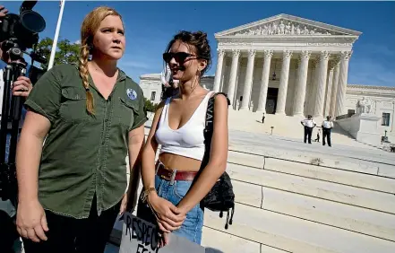  ?? AP ?? Amy Schumer, left, and Emily Ratajkowsk­i, attend a rally against Supreme Court nominee Brett Kavanaugh in front of the Supreme Court in Washington last weekend. They were later arrested.