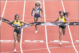  ??  ?? Jamaica's Elaine Thompson-Herah (L) wins the 100m at the Diamond League meet in Eugene.