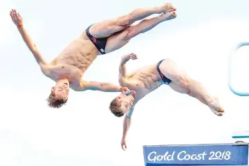  ?? — AFP photo ?? England’s Thomas Daley and England’s Daniel Goodfellow compete during the men’s synchronis­ed 10m platform diving in the 2018 Gold Coast Commonweal­th Games at the Optus Aquatic Centre on the Gold Coast on April 13, 2018.