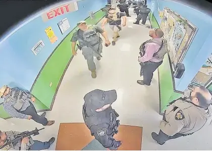  ?? Photo / AP ?? Surveillan­ce video shows first responders from agencies waiting in the hallway at Robb Elementary School.