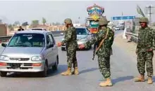  ?? AFP ?? Pakistani paramilita­ry soldiers stop a vehicle at a security check point in Peshawar yesterday, following a bomb attack on a 13th century Sufi shrine.