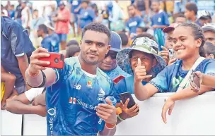  ?? Picture: JONACANI LALAKOBAU ?? Iosefo Masi takes a selfie with fans after the Super Rugby Pacific match at Churchill Park in Lautoka on Saturday.