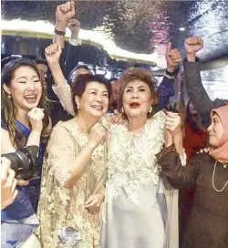 ?? AFP ?? Michelle’s mother Janet Yeoh upon hearing of her daughter’s victory while watching the show from Kuala Lumpur.