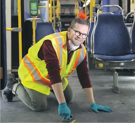  ?? JULIE OLIVER ?? Reporter Matthew Pearson suits up to help clean an OC Transpo bus, a day-long process that happens at least once every 180 days.