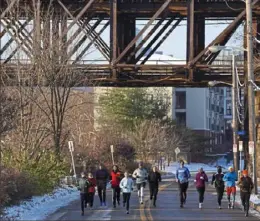  ?? Emily Matthews/Post-Gazette ?? Runners make their way down River Avenue as they finish up the Jan. 8 Pittsburgh Marathon Kickoff Training Run on the North Shore.