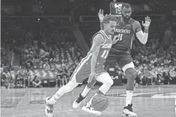  ?? AP ?? Hawks guard Trae Young drives by the Mavericks’ Tim Hardaway Jr. Thursday night in Atlanta. Young finished with 19 points and 14 assists.