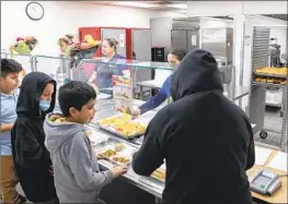  ?? Alberto Mariani Associated Press ?? AT V.H. LASSEN Academy of Science and Nutrition in Phoenix, students are eligible for free meals thanks to a federal program for low-income communitie­s.