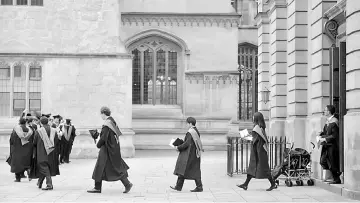  ??  ?? Graduates leave the Sheldonian Theatre after a graduation ceremony at Oxford University. The success of Oxford University’s US$1 billion bond, the first in its 1,000-year history, is good news for Britain’s top academic institutio­ns at a time of...