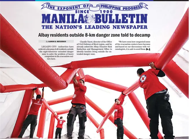  ??  ?? TENT DONATION – An inflatable tent that will serve as a temporary classroom for students displaced by the eruption of Mount Mayon is set up by Philippine Red Cross volunteers at the PRC logistics center in Pasig City. Five such tents were donated by...