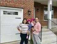  ?? NERDWALLET VIA AP ?? This undated photo provided by Nerdwallet shows from left, Allison, Abigail, Isabel and Matt Weil in front of a their new home in Laurel, Md. The Weils have twice used mortgage loans from Matt’s parents to buy a home.